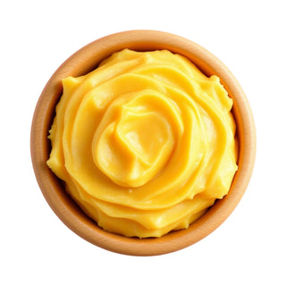Wooden bowl of creamy yellow mango butter