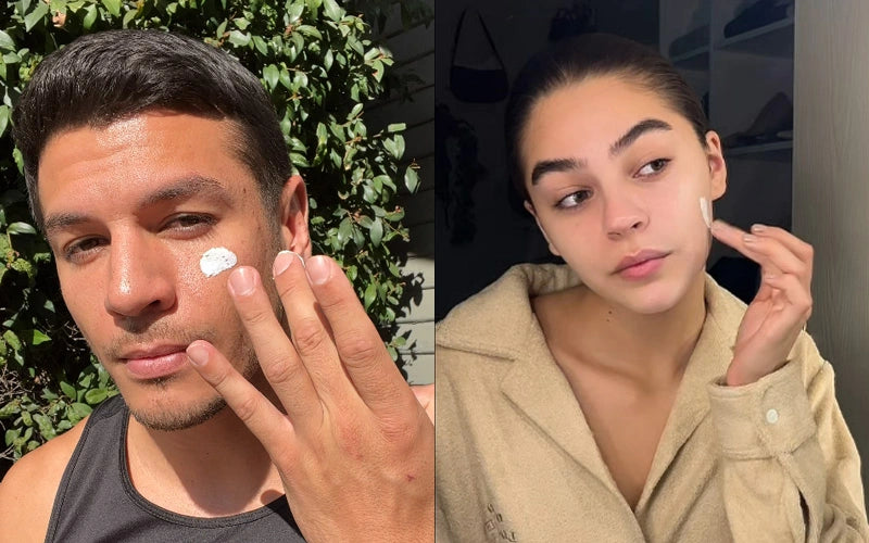 A man and a woman each smoothing The Everything Cream onto their cheeks
